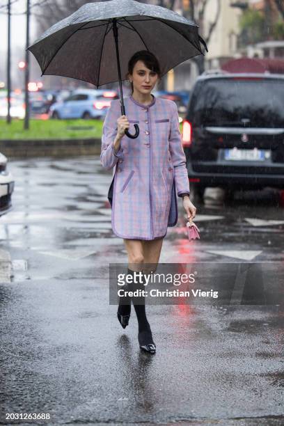 Mary Leest wears pink jacket, knee high socks, mini bag outside Armani during the Milan Fashion Week - Womenswear Fall/Winter 2024-2025 on February...