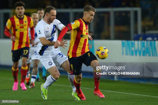 Inter Milan's Brazilian defender Carlos Augusto fights for the ball with Lecce's Sweden's forward Pontus Almqvist during the Italian Serie A football...
