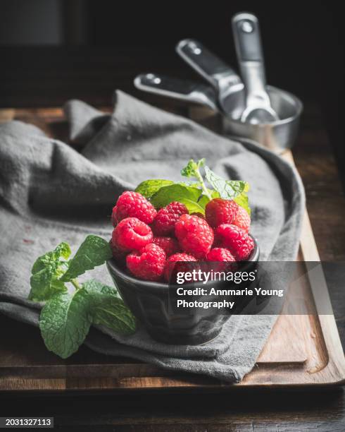 fresh raspberries and mint in rustic kitchen - raspberry stock pictures, royalty-free photos & images
