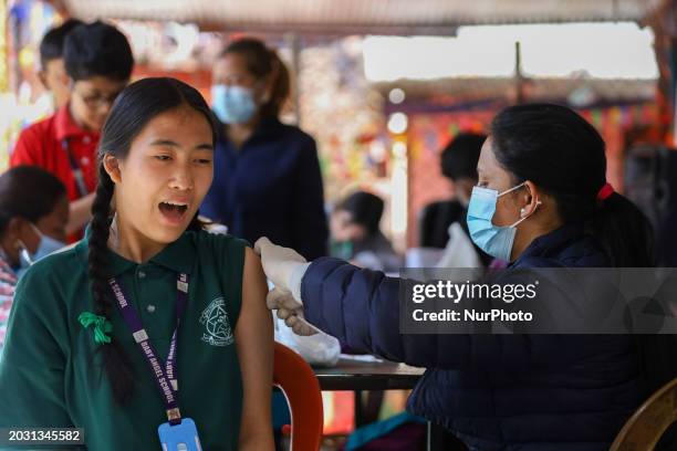 Nepali student is reacting as a paramedic administers a vaccine against measles-rubella at a local school in Kathmandu, Nepal, on February 25, 2024....