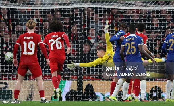Chelsea's Serbian goalkeeper Djordje Petrovic dives but is unable to prevent a header from Liverpool's Dutch defender Virgil van Dijk beating him...