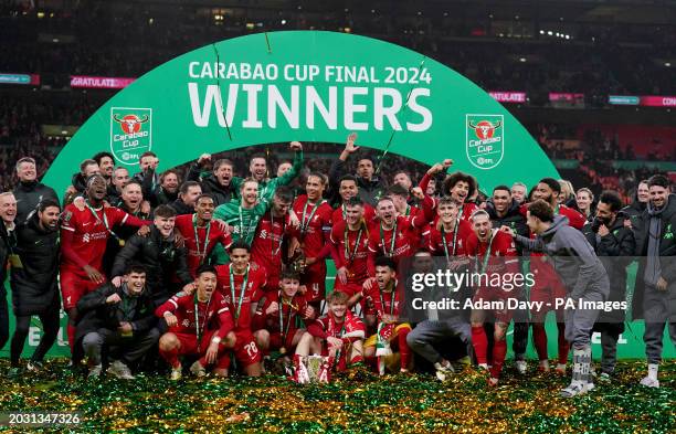 Liverpool players celebrate on the pitch with the trophy after winning the Carabao Cup final at Wembley Stadium, London. Picture date: Sunday...