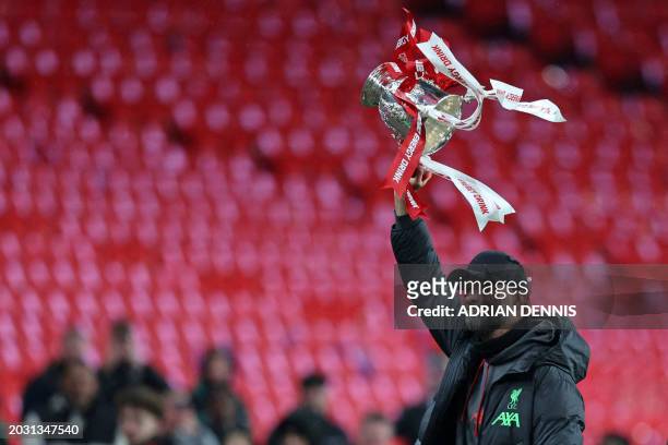 Liverpool's German manager Jurgen Klopp celebrates witht he tropy following the English League Cup final football match between Chelsea and Liverpool...