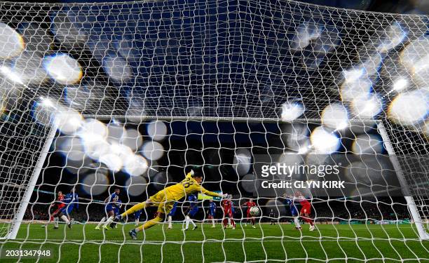 Liverpool's Dutch defender Virgil van Dijk scores the wining goal past Chelsea's Serbian goalkeeper Djordje Petrovic, in extra time during the...