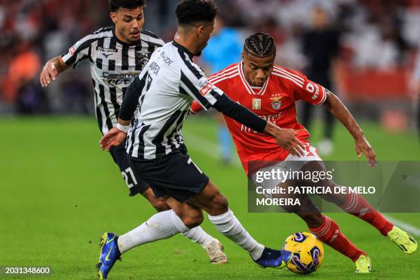 Benfica's Brazilian forward David Neres vies with Portimonense's Bulgarian forward Sylvester Jasper and Portimonense's Portuguese defender Guga...
