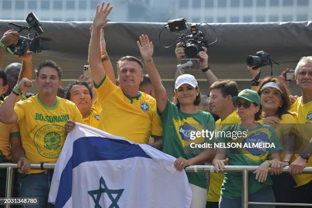 Former Brazilian President Jair Bolsonaro greets supporters next to his wife Michelle Bolsonaro during a rally in Sao Paulo, Brazil, on February 25...