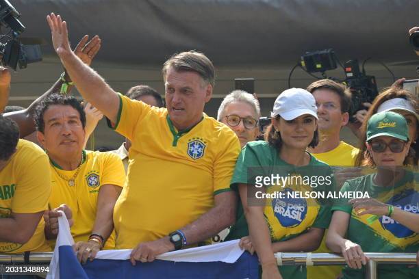 Former Brazilian President Jair Bolsonaro greets supporters next to his wife Michelle Bolsonaro during a rally in Sao Paulo, Brazil, on February 25...