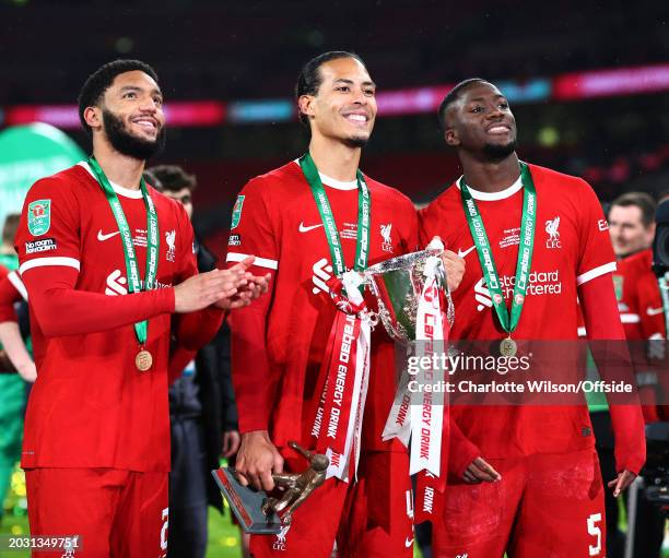 Joe Gomez, Virgil van Dijk and Ibrahima Konate of Liverpool pose with the trophy during the Carabao Cup Final match between Chelsea and Liverpool at...