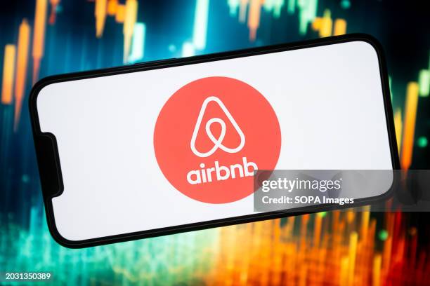 In this photo illustration, an Airbnb logo seen displayed on a smartphone.