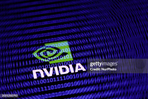 Binary code displayed on a laptop screen and Nvidia logo displayed on a phone screen are seen in this multiple exposure illustration photo taken in...