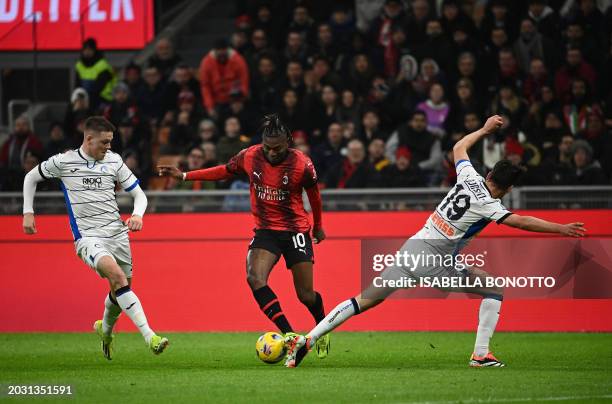 Milan's Portuguese forward Rafael Leao vies with Atalanta's Swedish defender Emil Holm and Atalanta's Albanian defender Berat Djimsiti during the...