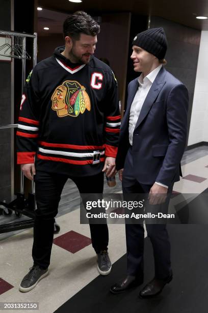 Patrick Kane of the Detroit Red Wings talks with former teammate Brent Seabrook prior to the game between the Chicago Blackhawks and the Detroit Red...