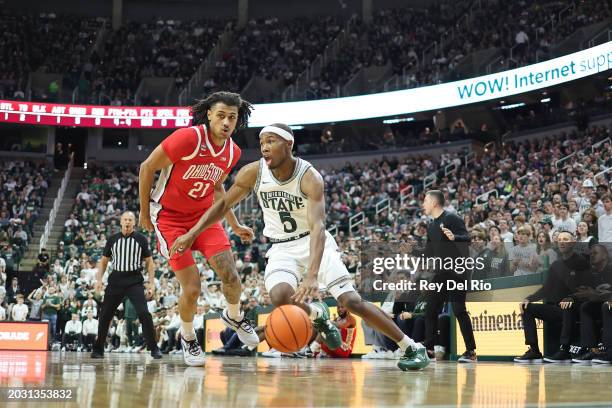 Tre Holloman of the Michigan State Spartans drives baseline against Devin Royal of the Ohio State Buckeyes during the first half at Breslin Center on...