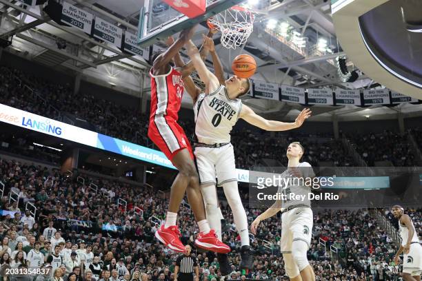 Felix Okpara of the Ohio State Buckeyes dunks against Jaxon Kohler of the Michigan State Spartans in the second half at Breslin Center on February...
