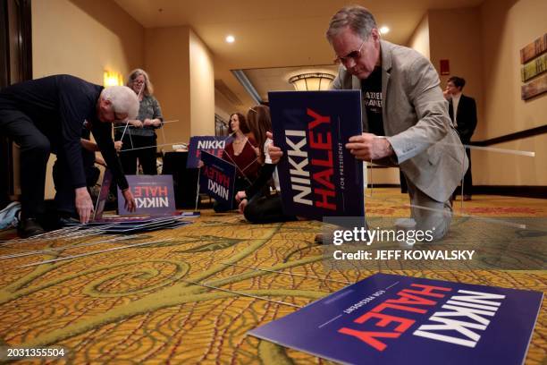 Volunteer puts together yard signs before US Republican presidential hopeful and former UN Ambassador Nikki Haley speaks at a rally in Troy,...