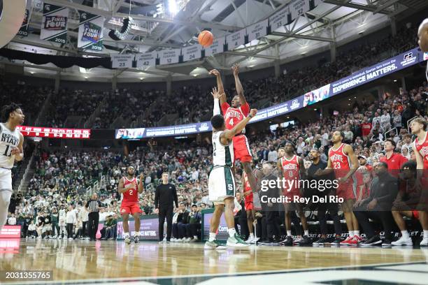 Dale Bonner of the Ohio State Buckeyes shoots the game-winning shot over Tyson Walker of the Michigan State Spartans at Breslin Center on February...