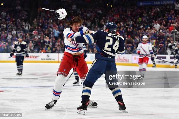 Matt Rempe of the New York Rangers and Mathieu Olivier of the Columbus Blue Jackets fight during the first period of a game at Nationwide Arena on...