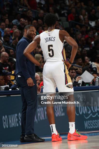 Head Coach Willie Green of the New Orleans Pelicans talks with Herb Jones during the game against the Chicago Bulls on February 25, 2024 at the...