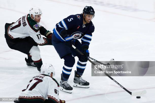 February 25: Winnipeg Jets defenseman Brenden Dillon skates away from Arizona Coyotes forward Nick Bjugstad during the regular season game between...