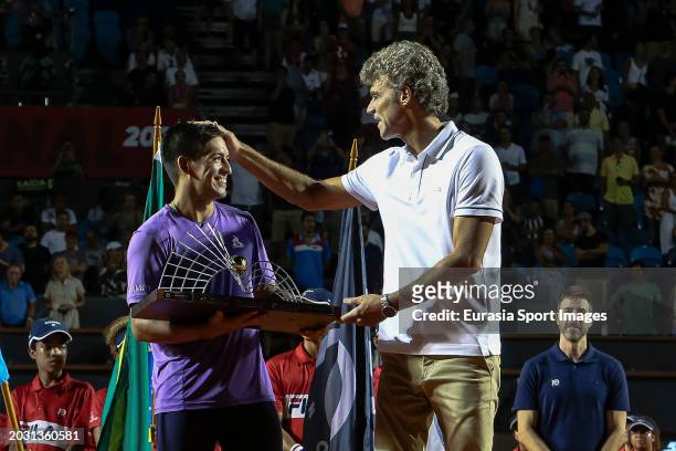 Brazilian former world No. 1 tennis player Gustavo Kurten awards Sebastian Baez of Argentina who celebrates a victory after his match against Mariano...