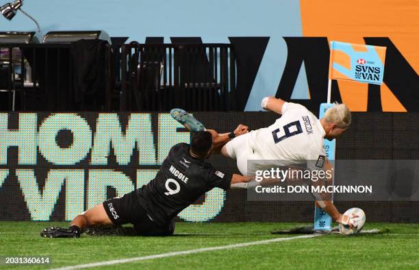 Argentina's Matias Osadczuk scores a try with New Zealand's Amanaki Nicole tackling him during the 2024 HSBC Canada Sevens rugby tournament match...