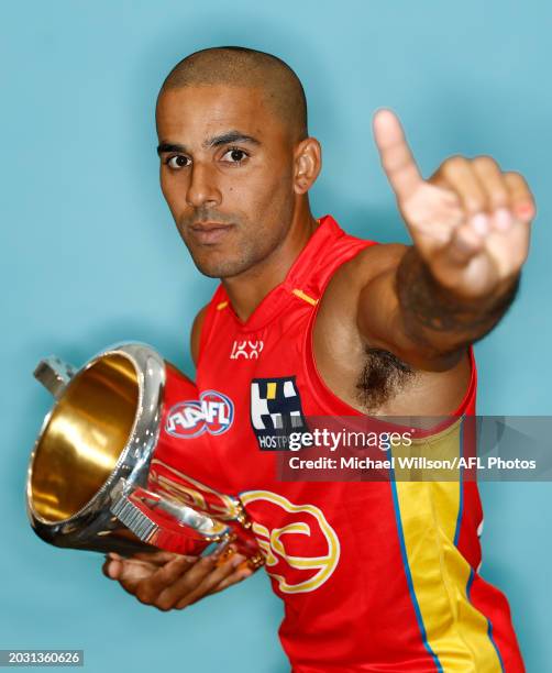 Touk Miller of the Suns poses for a photograph with the Premiership Cup during the 2024 AFL Captains Day at Marvel Stadium on February 26 2024 in...