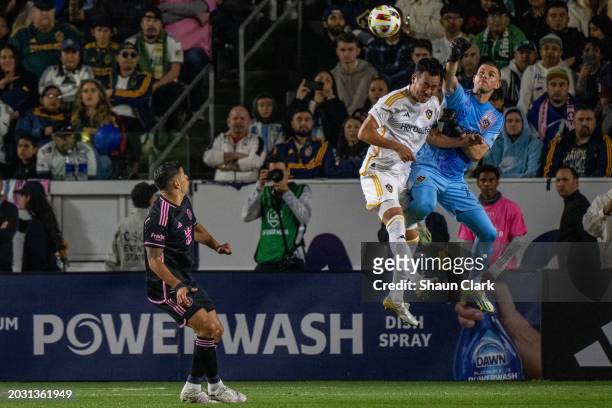 John McCarthy of Los Angeles Galaxy punches the ball clear as Maya Yoshida of Los Angeles Galaxy tries to head it during the match against Inter...