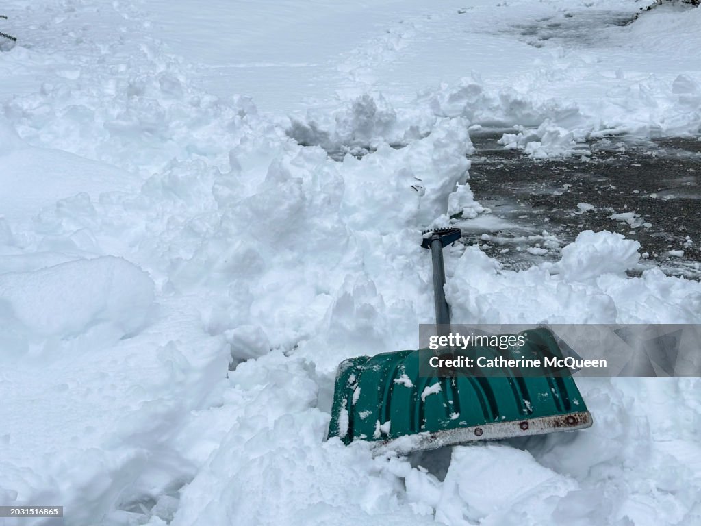 Large shovel left on top of snow