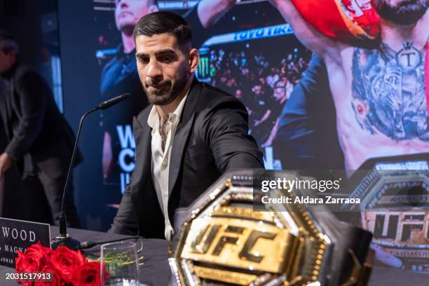 Ilia Topuria looks at the championship belt during the press conference after winning the UFC Featherweight Championship at Hotel Rosewood Villa...