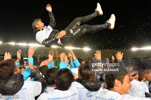 Head coach Takuya Takagi of V-Varen Nagasaki is tossed into the air as the team celebrates the promotion to the J1 following the 3-1 victory in the...