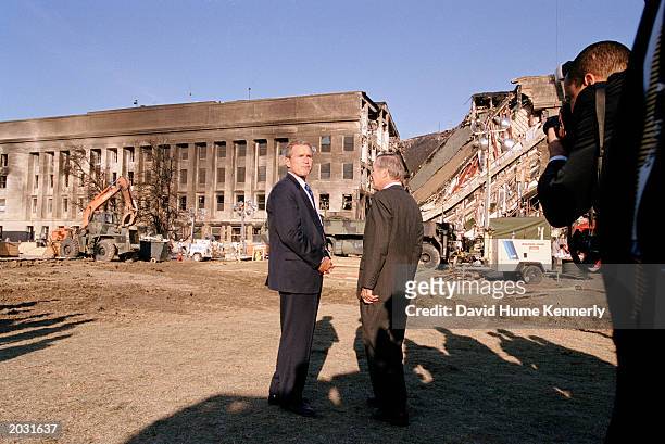 President George W. Bush and Secretary of Defense Donald Rumsfeld survey the damage at the Pentagon building September 12, 2001 in Arlington, VA a...