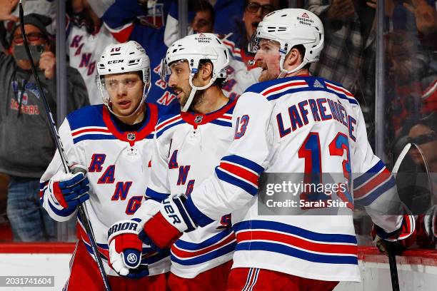 Artemi Panarin and Alexis Lafreniere celebrate with Vincent Trocheck of the New York Rangers after his goal during the third period against the New...