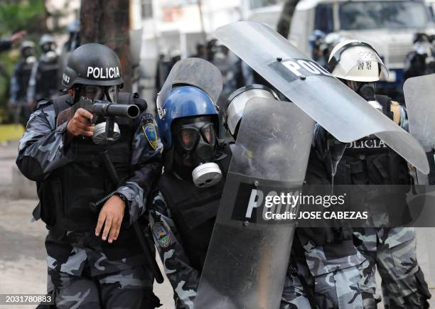 Riot squad agents face supporters of ousted Honduran President, Manuel Zelaya, in an effort to drive them away from the surroundings of the Brazilian...