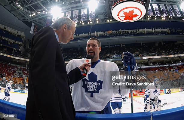 Owen Nolan of the Toronto Maple Leafs does an interview with Ron McLean of CBC before a game against the Vancouver Canucks at Air Canada Centre on...