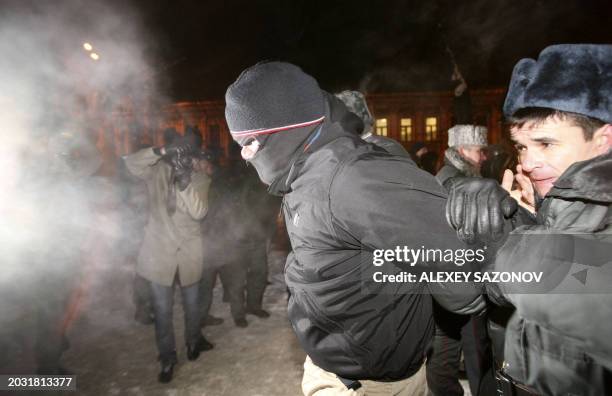 Russian police arrest an activist during a rally in Moscow on January 19, 2010 to mark one year from the high-profile killings of human rights lawyer...