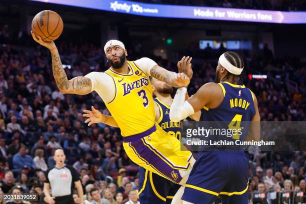 Anthony Davis of the Los Angeles Lakers goes to the basket against Stephen Curry and Moses Moody of the Golden State Warriors in the first half at...
