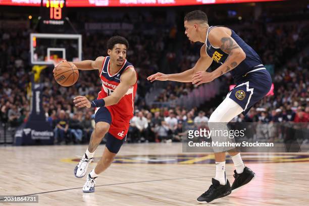 Jordan Poole of the Washington Wizards drives against Michael Porter Jr. #1 of the Denver Nuggets in the second quarter at Ball Arena on February 22,...
