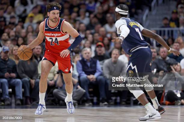 Corey Kispert of the Washington Wizards brings the ball down the court against Reggie Jackson of the Denver Nuggets in the first quarter at Ball...