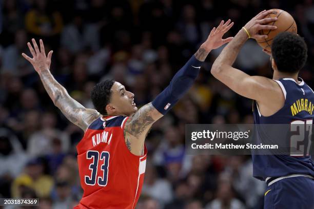 Kyle Kuzma of the Washington Wizards attempts to block Jamal Murray of the Denver Nuggets in the second quarter at Ball Arena on February 22, 2024 in...