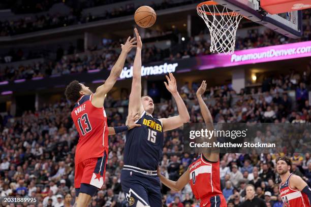 Nikola Jokic of the Denver Nuggets puts up a shot against Jordan Poole and Bilal Coulibaly of the Washington Wizards in the fourth quarter at Ball...