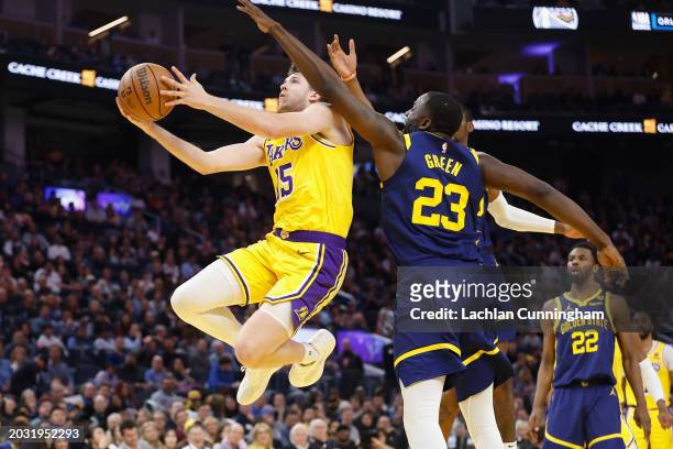 Austin Reaves of the Los Angeles Lakers goes to the basket against Draymond Green of the Golden State Warriors in the first half at Chase Center on...