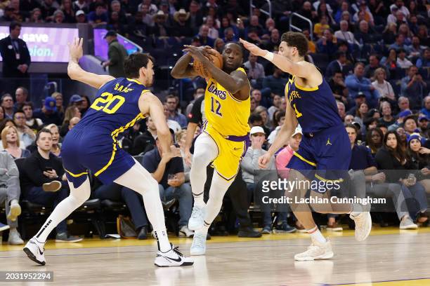 Taurean Prince of the Los Angeles Lakers drives to the basket against Dario Saric and Klay Thompson of the Golden State Warriors in the first half at...