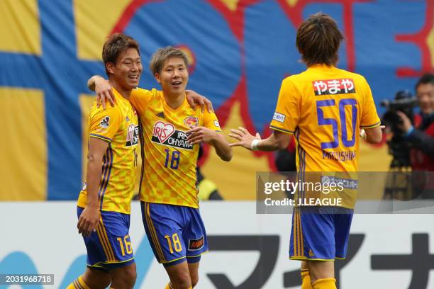 Hirotaka Mita of Vegalta Sendai celebrates with teammates Gakuto Notsuda and Tatsuya Masushima after scoring the team's third goal during the...