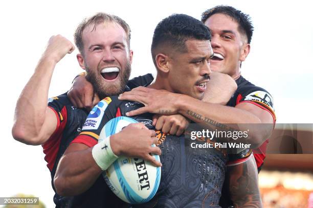 Xavier Roe and Quinn Tupaea of the Chiefs celebrate with Etene Nanai-Seturo of the Chiefs after he scored try during the round one Super Rugby...