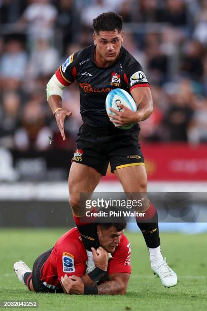 Quinn Tupaea of the Chiefs breaks the tackle during the round one Super Rugby Pacific match between Chiefs and Crusaders at FMG Stadium Waikato, on...