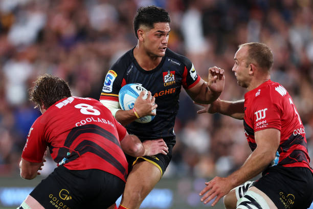 Quinn Tupaea of the Chiefs is tackled during the round one Super Rugby Pacific match between Chiefs and Crusaders at FMG Stadium Waikato, on February...