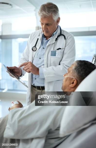 doctor, tablet and patient on with research for results, diagnosis or healthcare consultation at hospital. senior, male person or medical surgeon showing client procedure on technology at clinic - post operative stock pictures, royalty-free photos & images