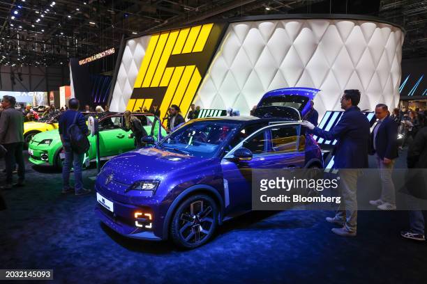 Attendees surround the Renault SA R5 E-Tech city car after its unveiling on the opening day of the Geneva International Motor Show in Geneva,...