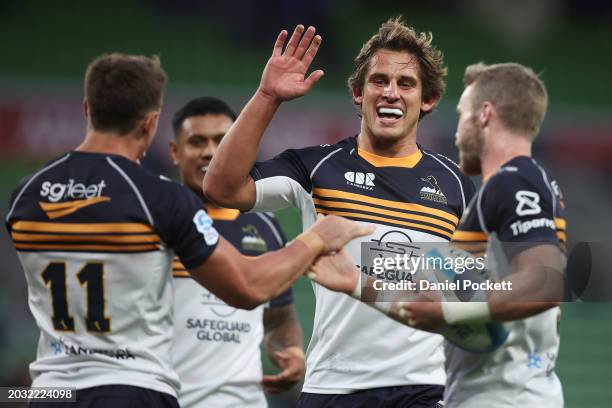 Corey Toole of the Brumbies celebrates scoring a try with Ollie Sapsford of the Brumbies and Ryan Lonergan of the Brumbies during the round one Super...