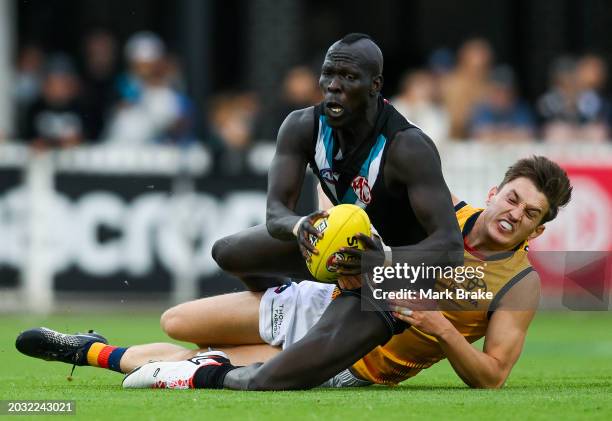 Aliir Aliir of the Power tackled by Lachlan Gollant of the Crows during an AFL practice match between Port Adelaide Power and Adelaide Crows at...